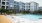Resort-style swimming pool with lounge seating