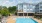 Resort-style swimming pool with lounge seating