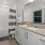 A spacious bathroom with a vanity and a tub