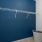 a walk-in closet with wire shelving and a blue wall